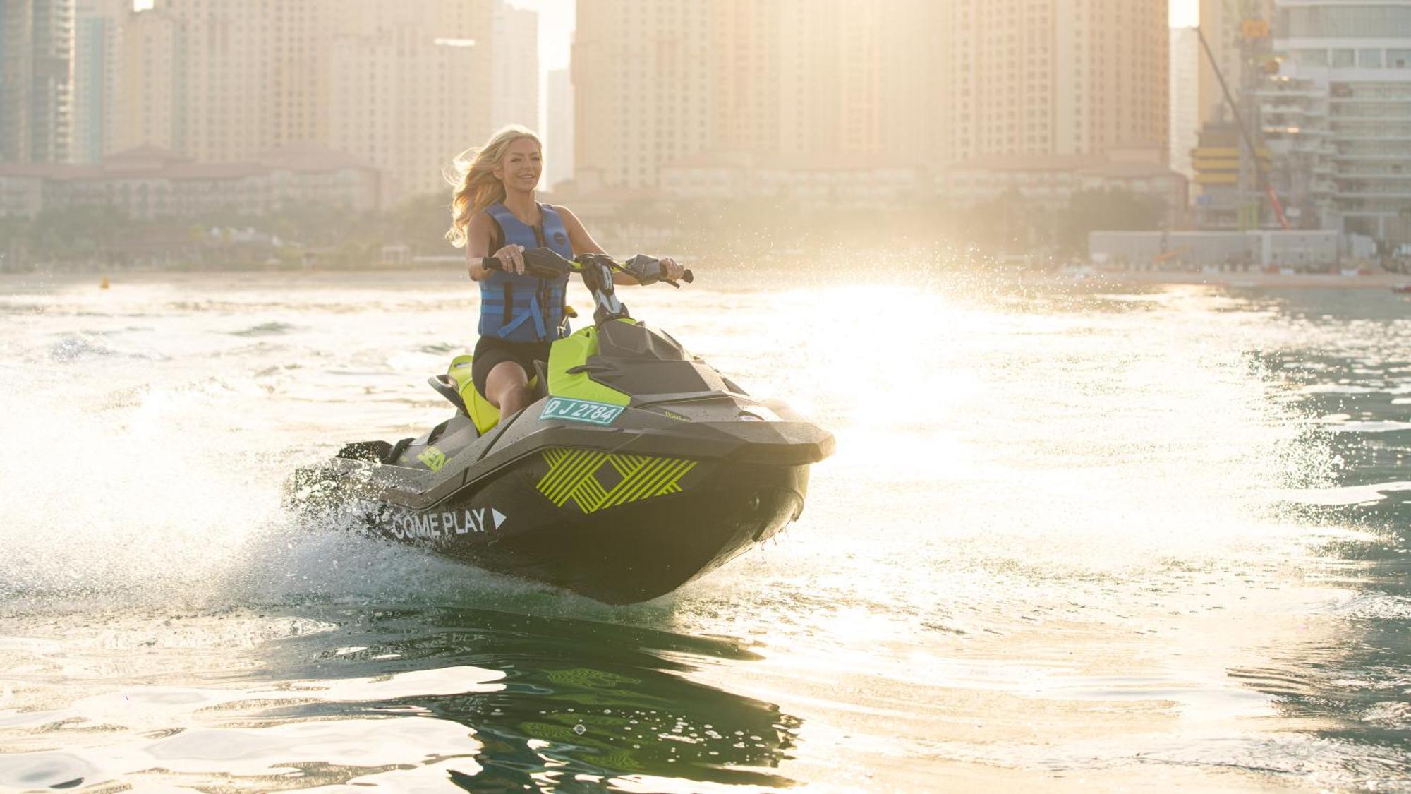 Five Luxe Hotel Дубай Екстериор снимка A woman riding a personal watercraft